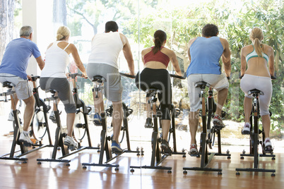 Group Of People In Spinning Class In Gym