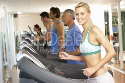 Woman On Running Machine In Gym