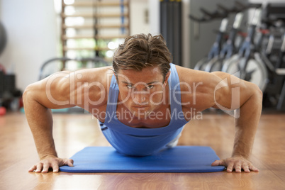 Man Doing Press Ups In Gym