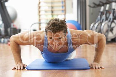 Man Doing Press Ups In Gym