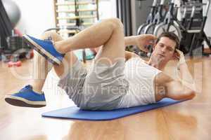 Man Doing Stretching Exercises In Gym
