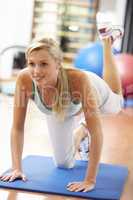 Young Woman Doing Stretching Exercises In Gym