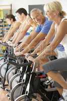 Senior Man Cycling In Spinning Class In Gym