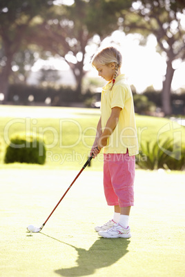 Young Girl Practising Golf On Putting On Green