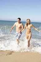 Young Couple Enjoying Beach Holiday