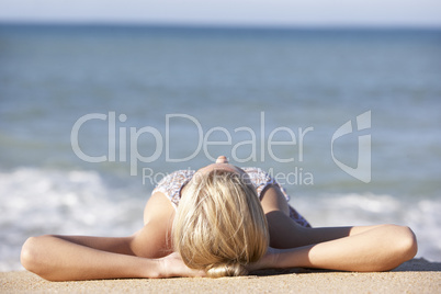 Young Woman Sunbathing On Beach