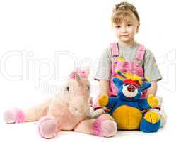 Girl surrounded by her toys