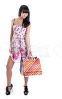 Happy girl with striped bags in transparent dress
