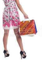 Tall woman legs with stiped shopping bags