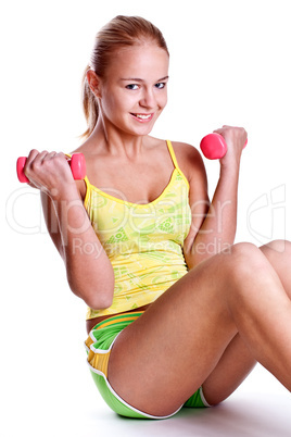 pink dumbbells in the hands of women