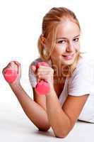 pink dumbbells in the hands of women