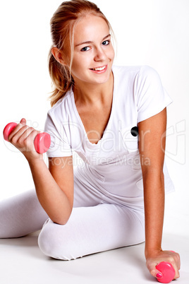 pink dumbbells in the hands of women