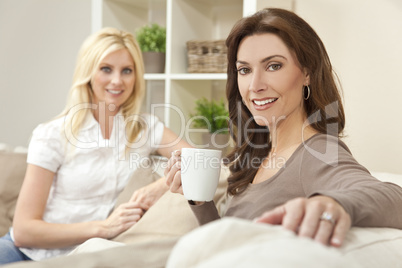 Two Beautiful Women Friends Drinking Tea or Coffee at Home