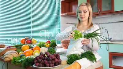 Pregnant woman with Groceries in kitchen