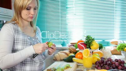 Pregnant woman preparing fruit salad