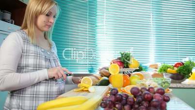 Pregnant woman cutting lemon