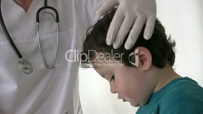 Pediatrician checking little boy