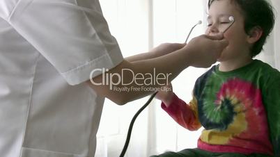 Pediatrician checking little boy