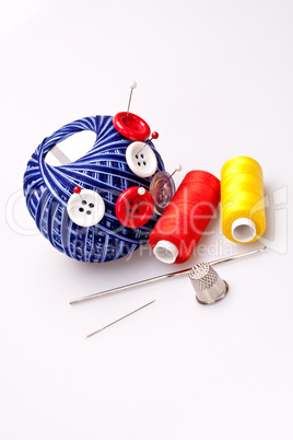 pins in wool ball with buttons