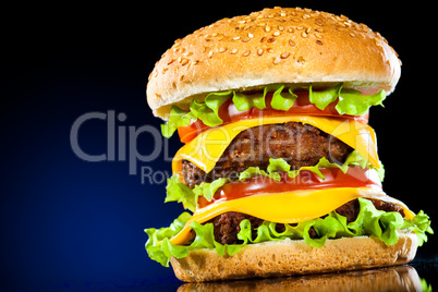 Tasty and appetizing hamburger on a dark blue