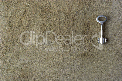 Iron key on a concrete wall