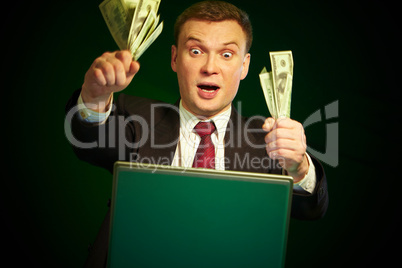 man with money in hands at the monitor