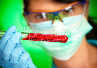 scientist in laboratory with test tubes