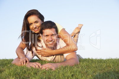 Young couple posing on a field