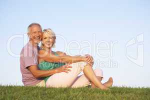 Senior couple posing on a field