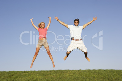 Young couple jumping in air