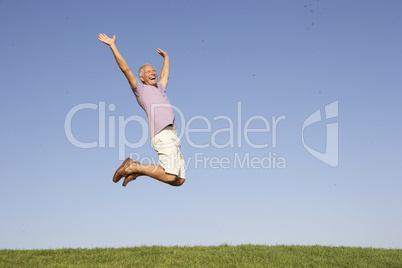 Senior man jumping in air
