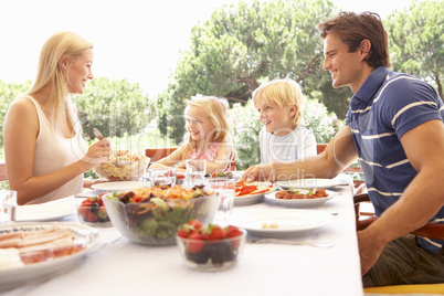 Parents, with children, enjoy a picnic