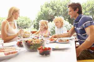 Parents, with children, enjoy a picnic