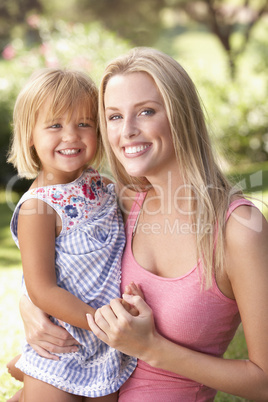 Portrait Of Mother And Child Relaxing In Park