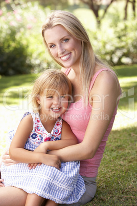 Portrait Of Mother And Child Relaxing In Park Portrait Of Mother And Child Relaxing In Park