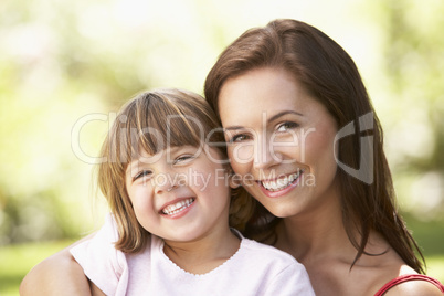 Portrait Of Mother And Child Relaxing In Park