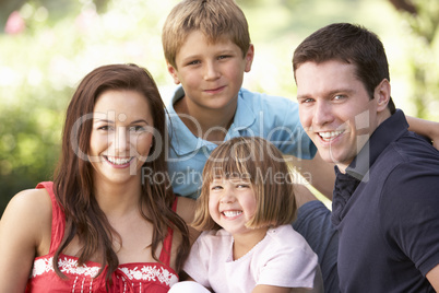 Portrait Of Young Family Relaxing In Park