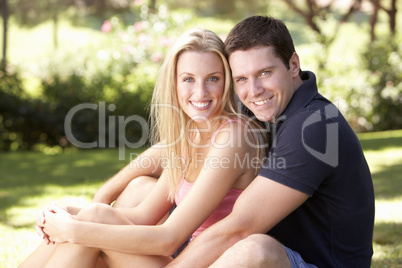 Portrait Of Young Couple Relaxing In Park