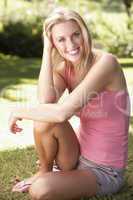 Portrait Of Young Woman Relaxing In Park