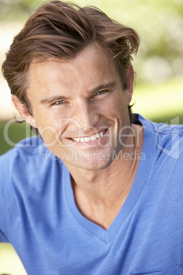 Portrait Of Young Man Relaxing In Park