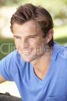 Portrait Of Young Man Relaxing In Park