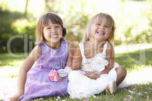 Two young girls posing in park