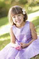 Portrait Of Bridesmaid Holding Bouquet Outdoors