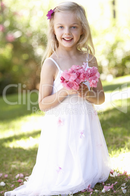 Portrait Of Bridesmaid Holding Bouquet Outdoors