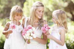 Bride With Bridesmaids Outdoors At Wedding