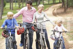 Family enjoying bike ride in park