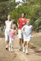 Family running on path in park