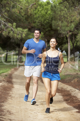 Young couple running in park