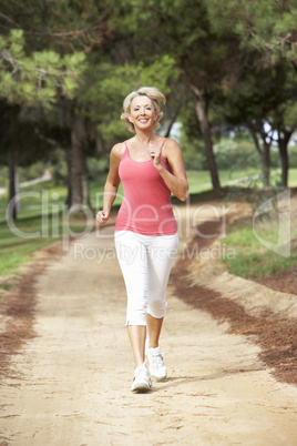 Senior woman running in park