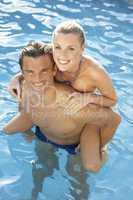 Young couple having fun in pool